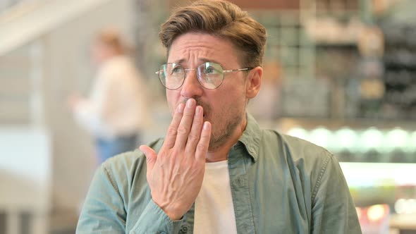 Portrait of Exhausted Middle Aged Man Yawning, 