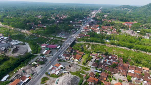 Traffic on highway through Kali Putih Bridge, infrastructure of Java, Indonesia