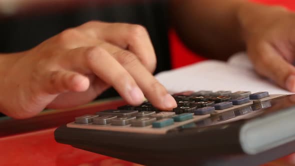 close-up hand of businessman using a calculator