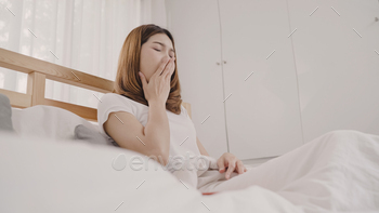 Asian woman dreaming while sleeping on bed in bedroom. / Photodune, Misc