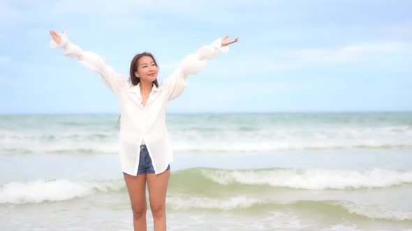 Asian woman enjoy around beautiful beach sea ocean