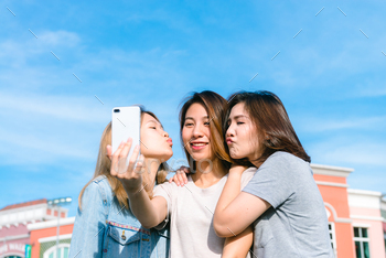 Attractive beautiful asian friends women using a smartphone.
