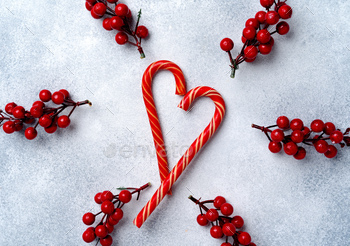 Candy canes on grey frosted background top view / Photodune, Misc