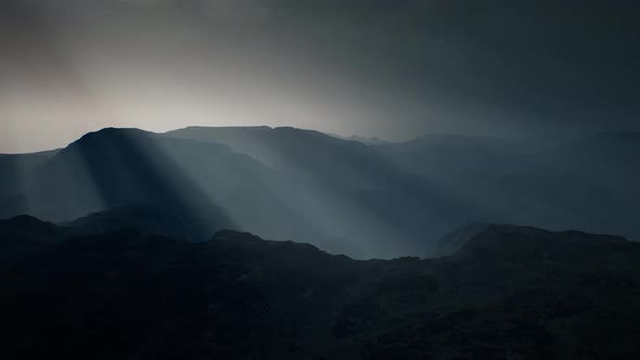 Black Rocky Mountain Silhouette in Deep Fog