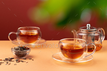 Glass teapot and two glass cups with tea / Photodune, Misc