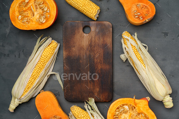 Variety of ripe vegetables including pumpkin and corn on dark background / Photodune, Misc