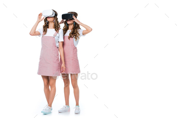 young twins using virtual reality headsets isolated on white / Photodune, Misc