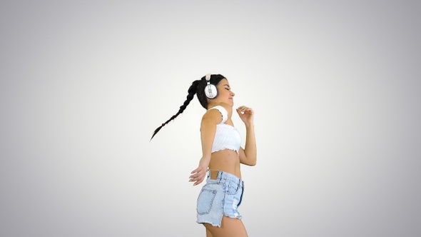 Latin woman with black hair enjoying music in headphones