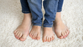 Closeup of female and child feet standing on soft carpet and moving toes - PhotoDune Item for Sale