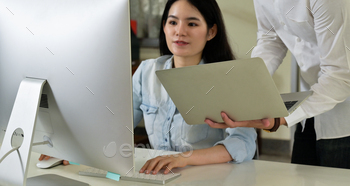 Men and women software developers working together with laptops and computers. / Photodune, Misc