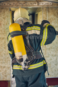 Firefighter wearing fireproof uniform standing in the indoors / Photodune, Misc