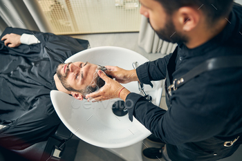 Close up of master washing hair before haircut / Photodune, Misc