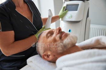 tofacial treatment while providing skincare for an elderly man