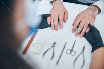 Close up of master examining male hands / Photodune, Misc