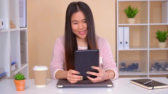 Asian Female Has Video Call at the Workplace