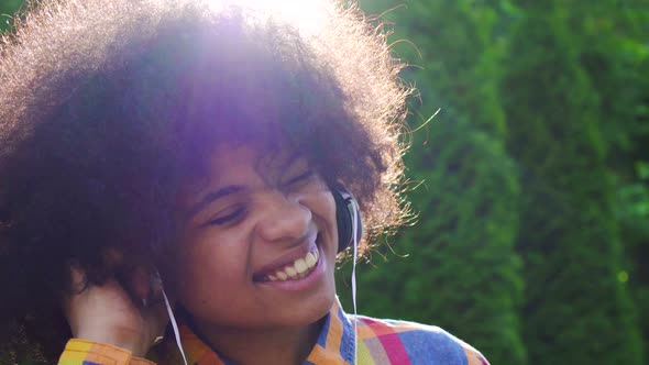 Portrait of Happy African American Woman with Afro Hairstyle in Shirt and Headphones