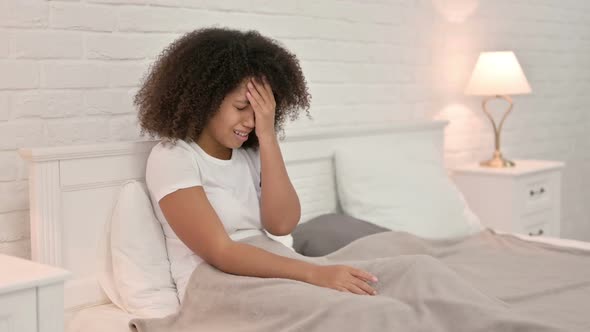 Upset Young African Woman Crying in Bed