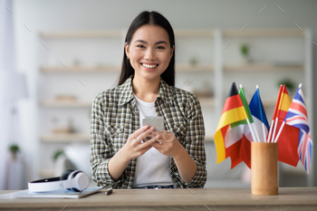 Cheerful asian young lady using smartphone, having English class / Photodune, Misc