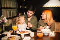 Parents with their curly daughter, having healthy meal together. Nutrition Concept. - PhotoDune Item for Sale