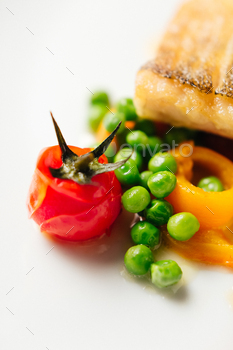 Grilled pollock or coalfish served with carrot, tomatoes and green beans. / Photodune, Misc