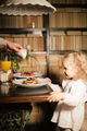 Family mother father and child have Breakfast in the cafe. Nutrition Concept. - PhotoDune Item for Sale