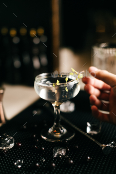 Bartender make drinks. Transparent cocktails  in glass on dark background. / Photodune, Misc