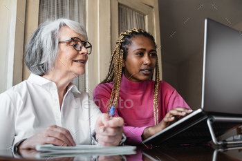 Multiracial young and senior people using computer laptop indoor at home / Photodune, Misc