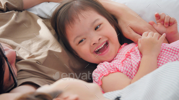 Happy family with mother, father and disabled daughter spending time together at home. / Photodune, Misc