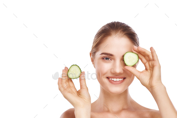Beautiful womans face with cucumber close-up studio on white. / Photodune, Misc
