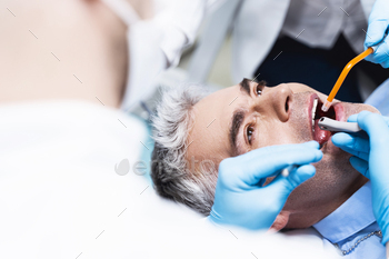 Man having root canal put stock photo / Photodune, Misc