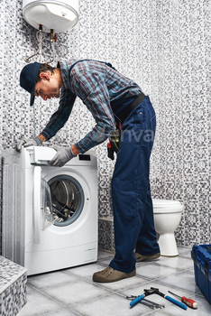 Checking washing machine work. Working man plumber in bathroom / Photodune, Misc