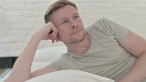 Man Lying in Bed and Thinking