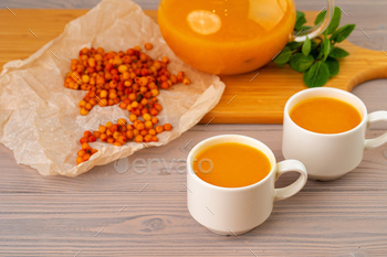 Sea buckthorn tea served on wooden table / Photodune, Misc