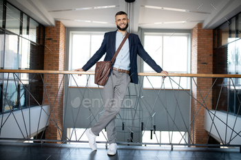 Office worker standing and waiting for his colleague near stairs / Photodune, Misc