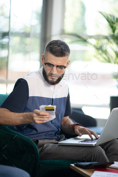 Bearded businessman analyzing expenses of his company / Photodune, Misc