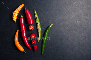 Colorful mix of chili pappers on black background. Free space for text / Photodune, Misc