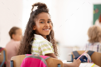 Cheerful girl feeling happy while attending school / Photodune, Misc