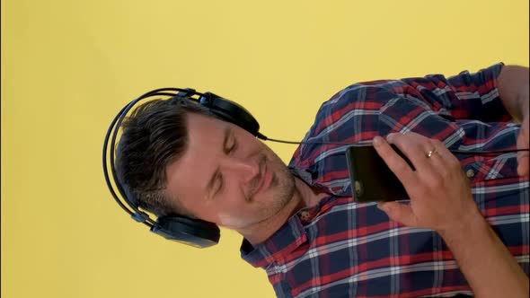 Handsome Man in Headphones Enjoying Listening To the Music