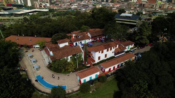 Residential resort on a hill overgrown with thick trees above the town of Medellin with a swimming p