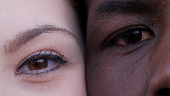  black man and white woman's eyes opening.Interracial race love concept-macro