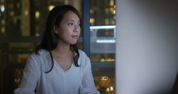 Woman work on computer at night