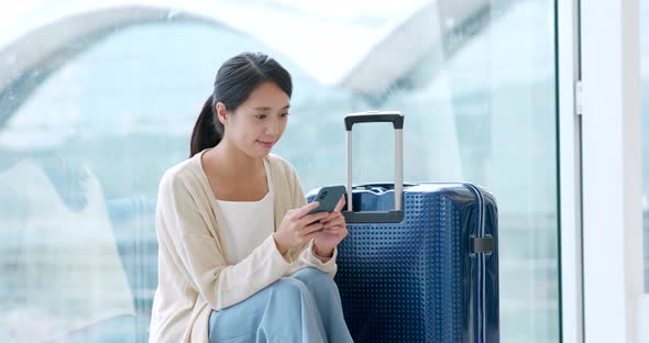 Young woman use of mobile phone in the airport