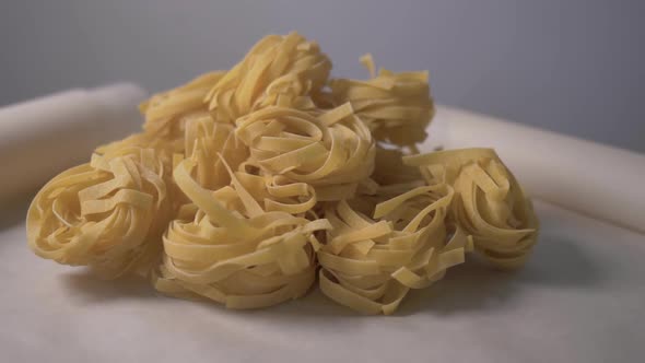 Fettuccine Pastas Nests Lie on the Table. Cooking Fettuccine Pastas Nests. Food Video. Concept