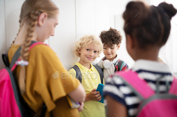 Classmates standing near lockers and enjoying school break / Photodune, Misc