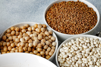 White ceramic bowls with assorted grains on kitchen table / Photodune, Misc