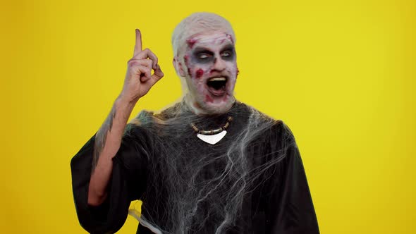 Inspired Halloween Crazy Zombie Man Pointing Finger Up with Open Mouth Showing Eureka Gesture