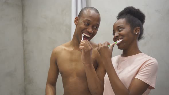 Cheerful Black Couple in Bathroom