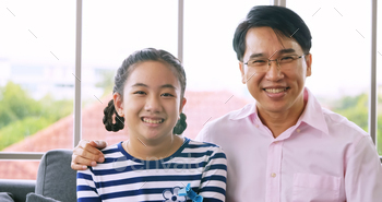 Portrait of Happy family with father and daughter smiling and looking at camera. / Photodune, Misc