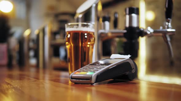 Buying Beer and Paying By Credit Bank Card Via Terminal Closeup