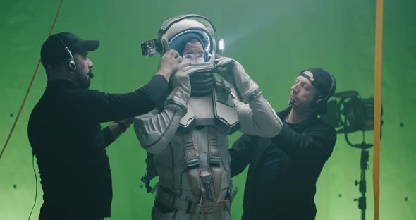 Crew Members Dressing an Actor